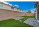 Artificial turf and paved patio create a low-maintenance backyard at 1450 Pink Dawn Dr, Henderson, NV 89014