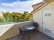 Private balcony with small table and chairs, offering a treetop view at 230 E Flamingo Rd # 402, Las Vegas, NV 89169