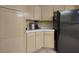 Kitchen corner with wood cabinets and black refrigerator at 2257 Bridle Wreath Ln, Las Vegas, NV 89156