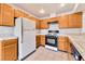 Clean kitchen with wood cabinets, and white appliances at 1751 E Reno Ave # 132, Las Vegas, NV 89119