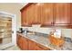 Butlers pantry with wood cabinetry, granite countertops, and ample storage space at 536 E Fairway Rd, Henderson, NV 89015