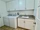 Convenient laundry room with white cabinets and granite countertop at 7365 Mission Hills Dr, Las Vegas, NV 89113