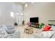 Spacious living room featuring high ceilings, tiled floors, and a fireplace at 10851 Piccata St, Las Vegas, NV 89141