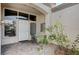 Charming front patio entry with small table and chairs, next to a rose bush at 9661 Blue Bell Dr, Las Vegas, NV 89134