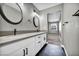 Modern bathroom with double vanity, hexagon tile floor, and updated fixtures at 2725 S Nellis Blvd # 1121, Las Vegas, NV 89121