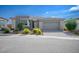 Single-Gathering home with gray exterior, paved driveway and landscaping at 4746 Se Argent Hills Ave, Pahrump, NV 89061