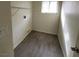 Laundry room with grey flooring, window and wire shelving at 8701 Shady Pines Dr, Las Vegas, NV 89143