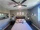 Serene bedroom featuring a ceiling fan, a full-size bed and nightstands at 690 Coastal Lagoon St, Henderson, NV 89002