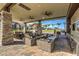 Relaxing outdoor kitchen and lounge area with ceiling fans at 9928 Regency Square Ave, Las Vegas, NV 89148