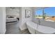 Main bathroom with freestanding bathtub and bedroom view at 1890 Eagle Flight Ln, Henderson, NV 89012