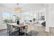 Dining room with wooden table and beige chairs, open to living room at 1890 Eagle Flight Ln, Henderson, NV 89012