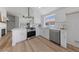 Well-equipped kitchen with white shaker cabinets and a large island at 7025 Dramatic Way, Las Vegas, NV 89130