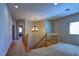 Upstairs hallway with a chandelier and staircase to the lower level at 9209 Tudor Park Pl, Las Vegas, NV 89145