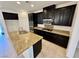 Spacious kitchen with granite countertops and dark wood cabinets at 7253 Blooming Jasmine Ave, Las Vegas, NV 89117