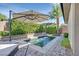 Relaxing backyard oasis featuring a refreshing pool, patio, and lush landscaping at 22 Via Del Fiume, Henderson, NV 89011