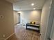 Upstairs hallway with wood-look flooring, leading to bedrooms at 8105 Switchback Run St, Las Vegas, NV 89166