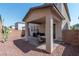 Covered patio with seating area, grill, and desert landscaping at 7915 Forspence Ct, Las Vegas, NV 89166