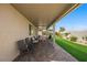 Relaxing covered patio with seating area and view of grassy backyard at 1047 Atkins Ln, Mesquite, NV 89027