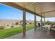 Covered patio with artificial turf and seating area at 1047 Atkins Ln, Mesquite, NV 89027