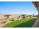 Artificial turf lawn with desert landscaping and a brick pathway at 1047 Atkins Ln, Mesquite, NV 89027