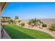 Artificial turf lawn with desert landscaping and a covered patio at 1047 Atkins Ln, Mesquite, NV 89027