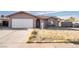 Beige one-story house with a two-car garage at 528 Close Ave, Henderson, NV 89011