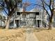 Two-story duplex with gray siding, stairs, and trees in front at 1912 Nebula Dr, Las Vegas, NV 89115