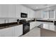 Modern kitchen with white cabinets, granite counters, and black appliances at 877 Royal Amethyst Way, Las Vegas, NV 89178