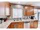 Kitchen corner sink with granite countertops and wood cabinets at 3881 Burma Rd, North Las Vegas, NV 89032