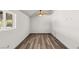 Spacious bedroom with ceiling fan, vinyl plank flooring and large window at 101 S Royalite St, Sandy Valley, NV 89019