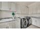 Bright laundry room, featuring granite countertops, and updated cabinetry at 4231 San Alivia Ct, Las Vegas, NV 89141