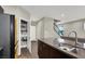 Modern kitchen with pantry and island with double sink at 63 Harrison Rose Ct, Las Vegas, NV 89110