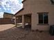 Side view of two-story house with covered patio and backyard at 137 Serpens Ave, Las Vegas, NV 89183