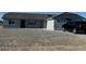 Single story home with gray exterior, attached garage, and gravel driveway at 1330 W Gee St, Pahrump, NV 89060