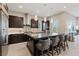 Modern kitchen with dark cabinetry, stainless steel appliances, and an island at 120 Los Cabos Dr # 301, Las Vegas, NV 89144