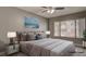 Virtually staged bedroom with neutral decor and large window at 3059 Key Largo Dr # 104, Las Vegas, NV 89120