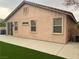 Rear exterior view showing stucco siding and small patio at 10762 Flame Vine Ct, Las Vegas, NV 89135