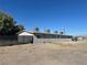 Rear view of building with grey exterior and chain link fence at 718 W Wilson Ave, Las Vegas, NV 89106