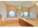 Elegant bathroom with double sinks, large mirror and a relaxing tub at 2877 Paradise Rd # 104, Las Vegas, NV 89109