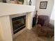 Living room fireplace with decorative mantle and comfy armchair at 2211 Rugged Mesa Dr, Laughlin, NV 89029