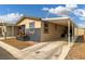 Mobile home with carport and well-maintained landscaping at 360 S Hilton Head St, Pahrump, NV 89048