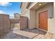 Front entry with orange door and gated yard at 6919 Denio Island St # 0, North Las Vegas, NV 89084