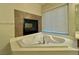 Corner soaking tub with fireplace at 6064 Alpine Estates Cir, Las Vegas, NV 89149