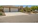 Single-story house with three-car garage and manicured landscaping at 6527 Lokai Ave, Las Vegas, NV 89130