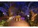 Relaxing patio seating area nestled under a large tree, illuminated at night at 2323 Pinto Ln, Las Vegas, NV 89107