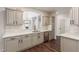 Modern kitchen with white cabinets, quartz countertops, and a large island at 801 Dana Hills Ct # 102, Las Vegas, NV 89134