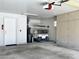 Attached garage with golf cart, storage cabinets, and epoxy flooring at 9100 Firebird Dr, Las Vegas, NV 89134