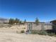 Gravel backyard with chain link fence and distant mountains at 1711 W Leffner Dr, Pahrump, NV 89060