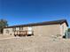 Tan colored house exterior with wood deck and gravel landscaping at 1711 W Leffner Dr, Pahrump, NV 89060