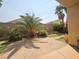 Backyard with a brick patio, artificial turf, and mature palm trees at 9265 Gentle Cascade Ave, Las Vegas, NV 89178